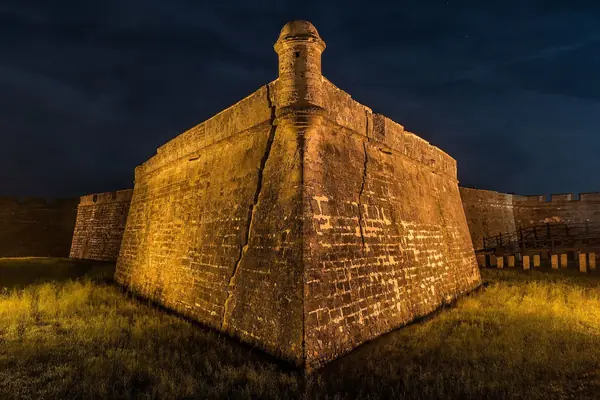 A bastion lit at night
