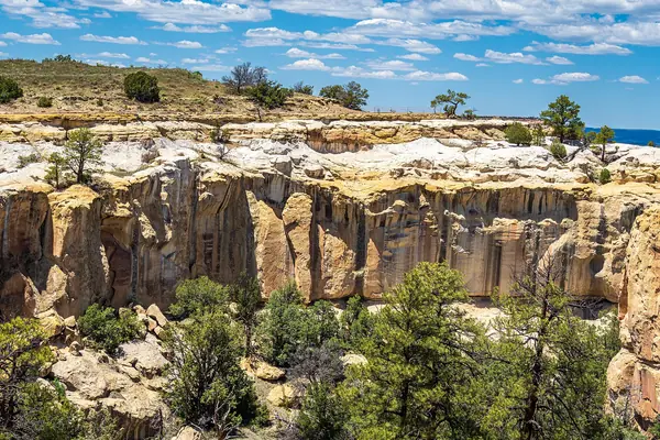 Atsinna Pueblo ruins atop the bluff