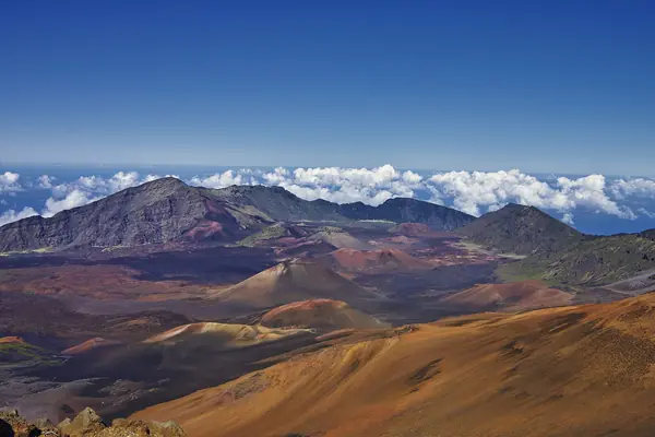 Clouds pour into the crater