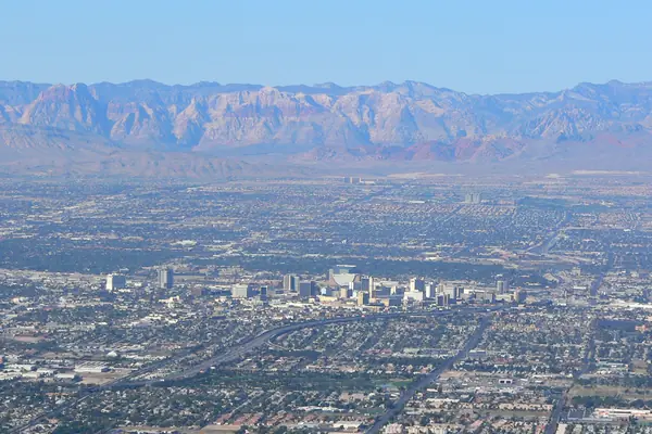 The city ringed by desert mountains