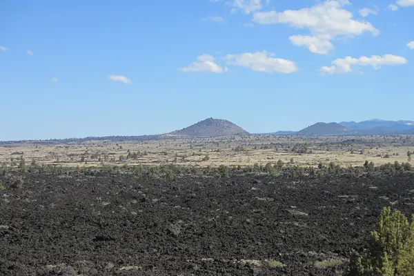 The volcanic plain and distant peaks