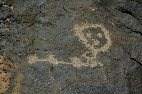 Petroglyphs cover the boulders