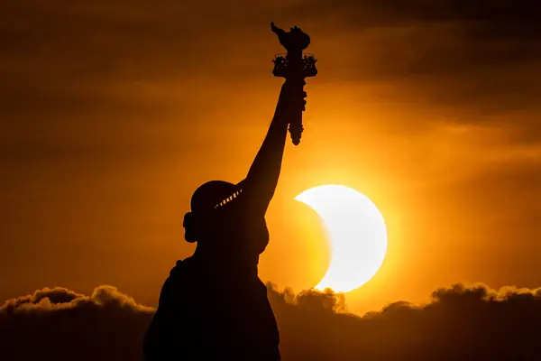 Silhouetted against an eclipse