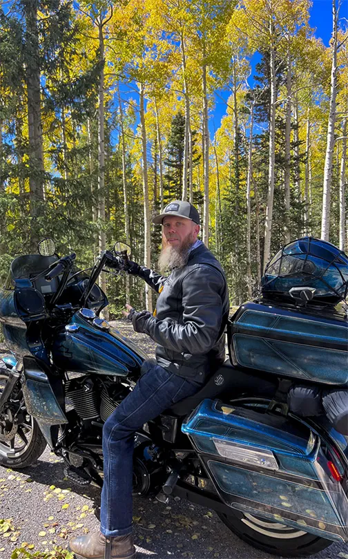 A TrippApps road tripper out on two wheels among the autumn aspens